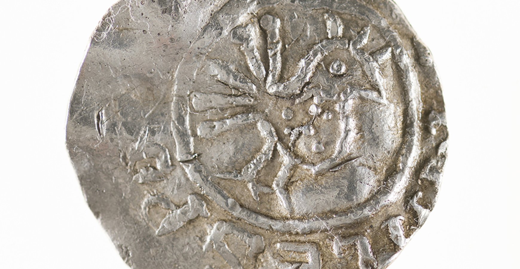 silver coin with a bird