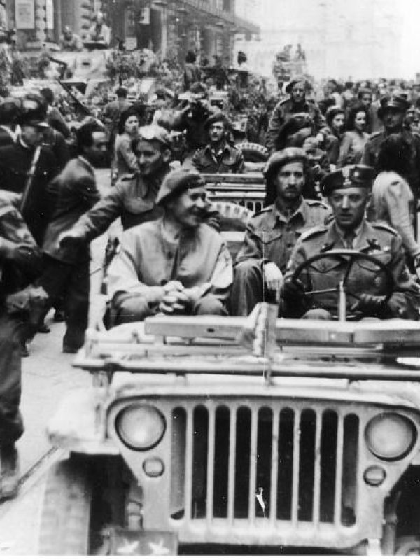 crowd of infantry soldiers and in military car black and white vintage photo